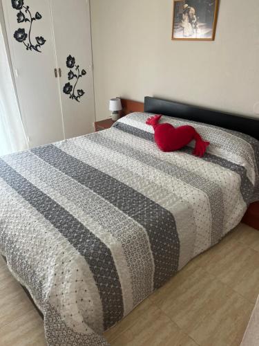 a red stuffed animal laying on top of a bed at Apartamento Hifrensa in Hospitalet de l'Infant