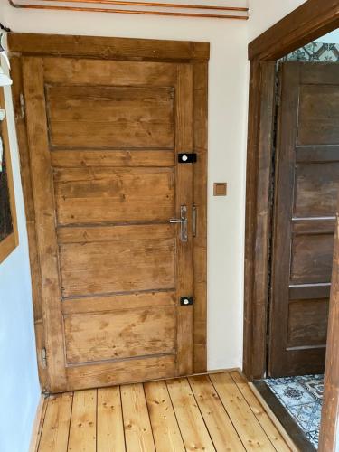 two wooden doors in a room with wooden floors at Apartmány Polská 12 in Olomouc