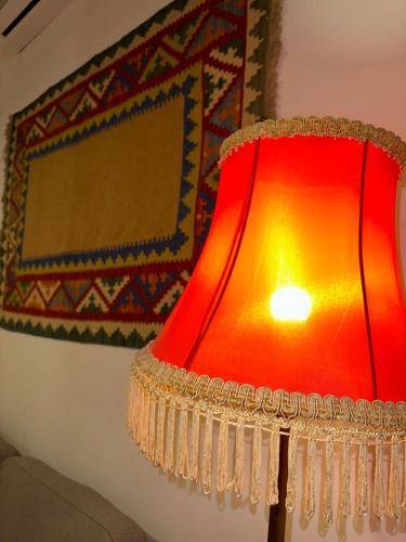 a red lamp in a room next to a wall at Salalak in Tbilisi City