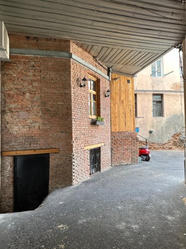 a brick building with a door and a garage at Salalak in Tbilisi City