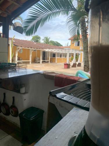 a view of a house with a palm tree at Suite familiar completa in Búzios