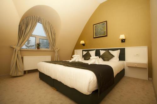 מיטה או מיטות בחדר ב-Family Hotel Saint George