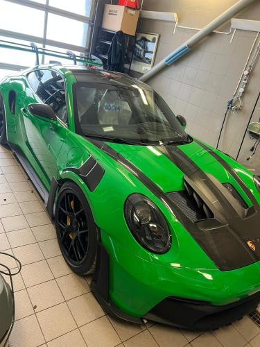 a green sports car parked in a garage at NRing Villa am Nürburgring in Adenau