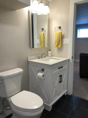 a bathroom with a white toilet and a sink at Cozy Getaway near SLC Airport & Downtown - 1st floor Apartment in Salt Lake City