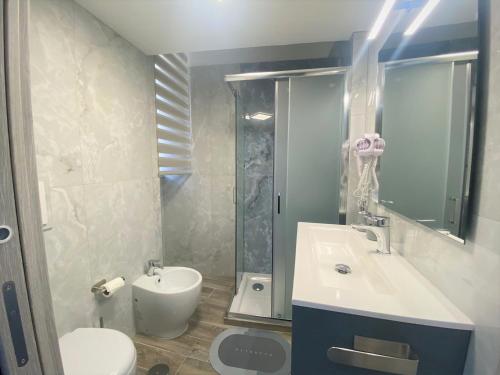 a bathroom with a sink and a toilet and a shower at Guest Amatur in Ercolano