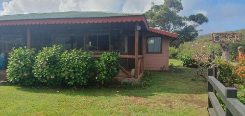 a small cabin with a sign in front of it at Cabañas Christophe in Hanga Roa