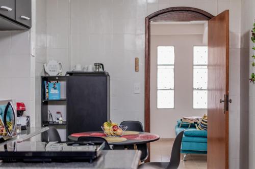 a living room with a table and a blue couch at Wabisabi Residence in Araxá