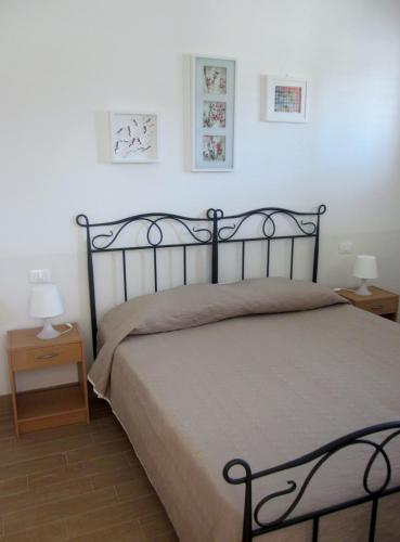a bedroom with a bed and two nightstand tables at Mare d'Amuri in Porto Empedocle
