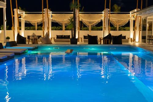 a swimming pool at night with blue lighting at Avaton Luxury Resort and Spa Access the Enigma - Adults Only & Kids 14 Plus- in Asprovalta