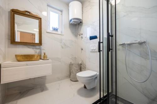 a bathroom with a shower and a toilet and a sink at Vuletić in Neum