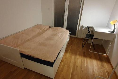 a small bedroom with a bed and a desk at Skopje home 5 in Skopje