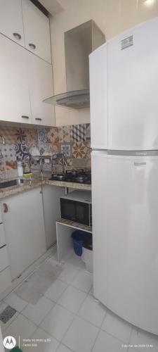 a kitchen with a white refrigerator in a room at Temporada Copacabana Salu 2 in Rio de Janeiro