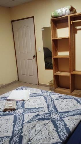 a room with a bed and a door and a shelf at Cabañas DondeJosé in Valle de Anton