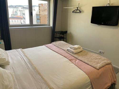 Ένα ή περισσότερα κρεβάτια σε δωμάτιο στο Liber Guest House