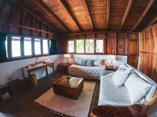 a living room with a couch and a table at Casa Laguna: Best View In The World in Santa Cruz La Laguna