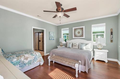 a bedroom with a bed and a ceiling fan at Almost Heaven in Dauphin Island