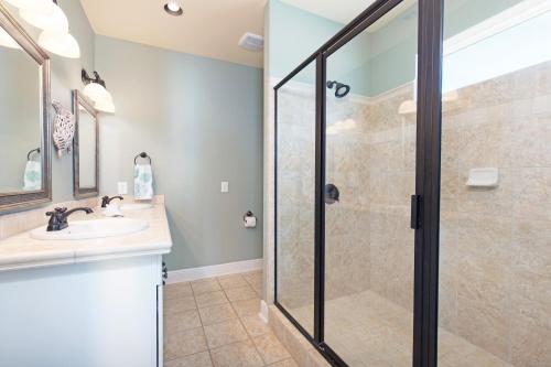 a bathroom with a shower and a sink at Almost Heaven in Dauphin Island