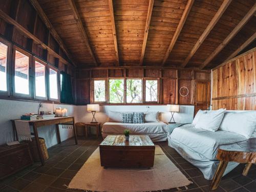 a living room with a couch and a table at Casa Laguna: Best View In The World in Santa Cruz La Laguna