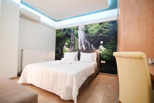 a bedroom with a bed with a waterfall mural on the wall at THE WHOLE PACKET Β3 center with parking in Larisa