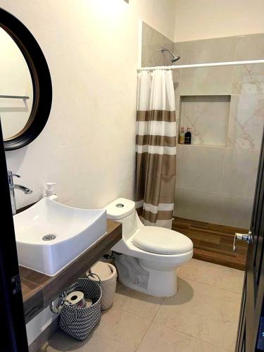 a bathroom with a sink and a toilet and a shower at Excelente Casa en Zona de Cerritos en Frente a Alberca - Azul Pacífico I in Mazatlán