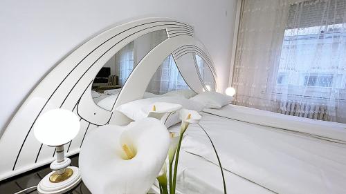 a white room with white chairs and a mirror at Hotel Splendid Ruse in Ruse