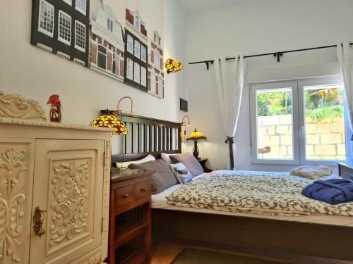 a bedroom with a large bed and a window at Sagittarius Home in Arico Viejo
