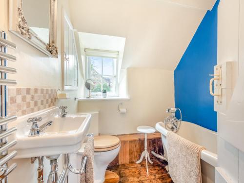 a bathroom with a sink and a toilet at Church House Cottage in East Stour