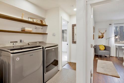 a small laundry room with a washer and dryer at Soaring Pines by Big Bear Vacations Central Cozy Estate Chalet in Big Bear Lake