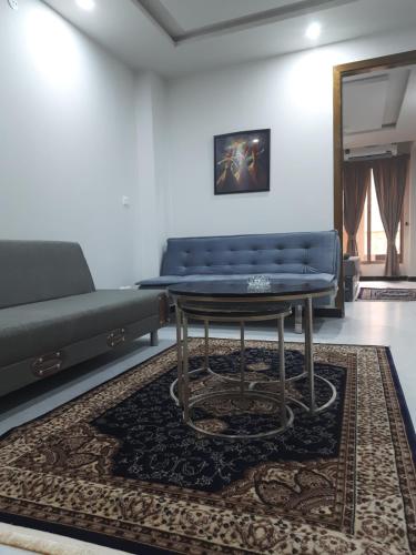 a living room with a couch and a table at Northern Suites Bahria town in Rawalpindi