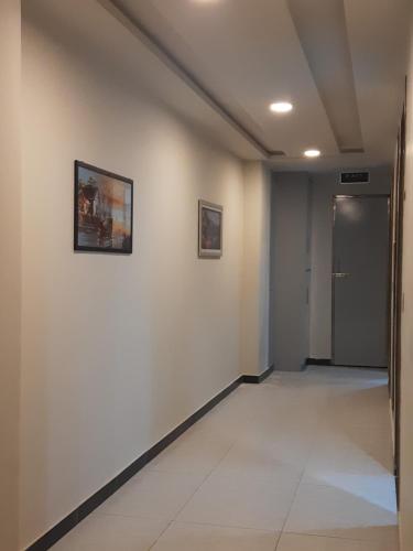 a hallway with white walls and a door at Northern Suites Bahria town in Rawalpindi