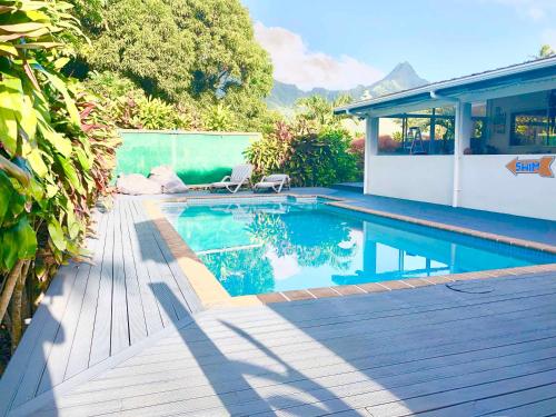 a swimming pool in a backyard with a house at Avarua Escape, Rarotonga in Avarua