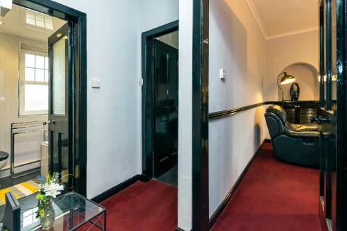 a hallway with a door leading to a living room at Cosy & Central 2BD Apartment Milngavie, Glasgow in Milngavie