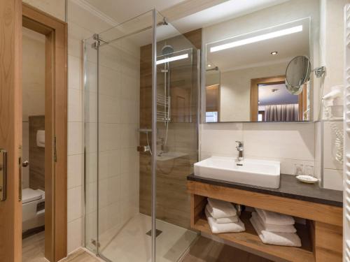 a bathroom with a sink and a shower at Ferienhof Oblasser in Mayrhofen