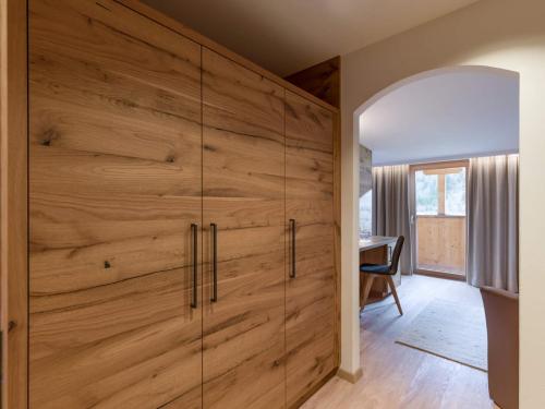 a large wooden closet in a room with a table at Ferienhof Oblasser in Mayrhofen