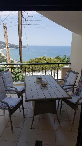 een houten tafel en stoelen op een balkon met uitzicht bij THE VIEW APARTMENT KAVALA in Kavala