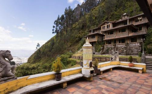 a stone building with a statue of a lion on a hill at Hacienda Rumiloma by Rotamundos in Quito