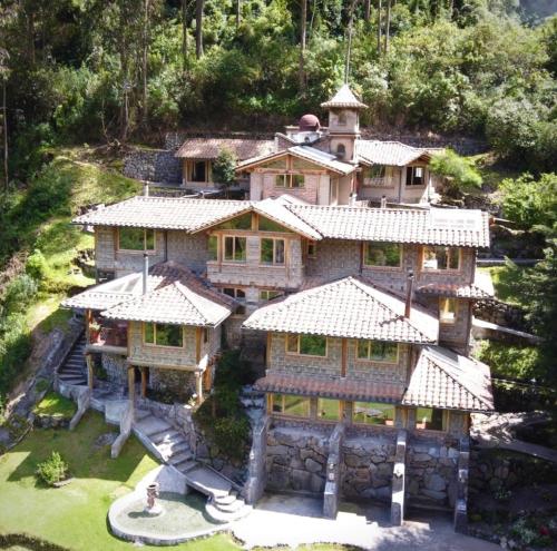 an aerial view of a house with a tower at Hacienda Rumiloma in Quito