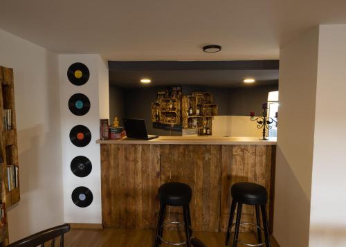 a bar with three vinyl records on the wall at Hostel Prishtina Backpackers in Pristina