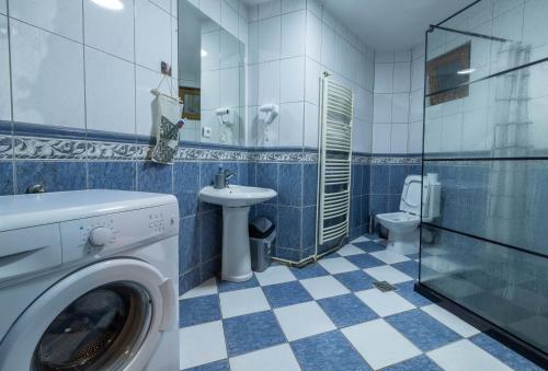 a bathroom with a washing machine and a toilet at Hostel Prishtina Backpackers in Pristina