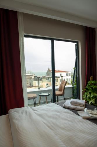 a bedroom with a bed and a view of the ocean at Linda Port Hotel in Istanbul