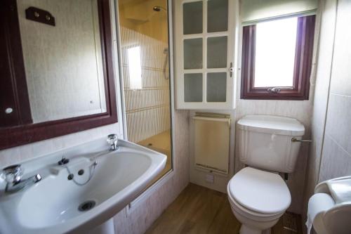 a bathroom with a toilet and a tub and a sink at Dog Friendly 6 Berth Static Caravan By The Beach In Hunstanton Ref 13008l in Hunstanton