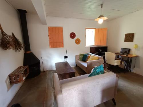 a living room with a couch and a table at Casa Morango Gonçalves in Gonçalves