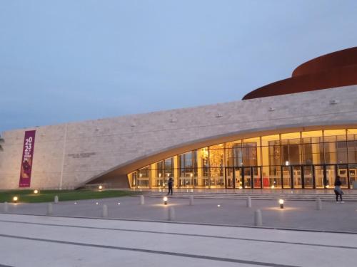 a large building with a large glass facade at night at Departamento Benissa en San Juan in San Juan