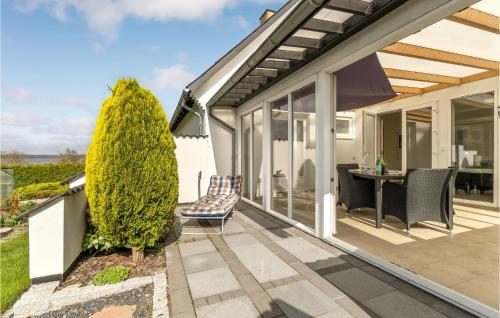 a house with a patio with a table and chairs at 4 Bedroom Amazing Home In Mariager in Mariager