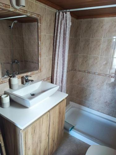 a bathroom with a sink and a toilet and a tub at Recanto do Oeste in São Pedro da Cadeira