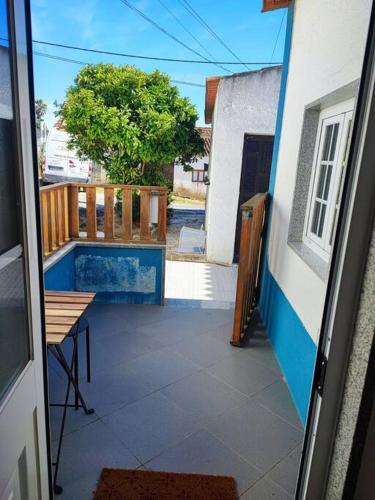 a view of a balcony with a table and a fence at Recanto do Oeste in São Pedro da Cadeira