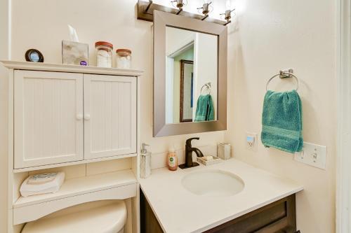 a white bathroom with a sink and a mirror at Cozy Lexington Townhome about 3 Mi to UK Campus! in Lexington