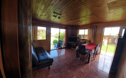 a living room with a couch and a table at Cabañas Christophe in Hanga Roa
