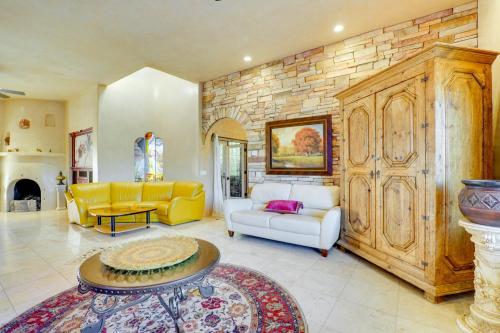 a living room filled with furniture and a stone wall at Pet-Friendly Tucson Vacation Rental with Huge Yard! in Tucson