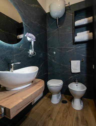 a bathroom with a sink and a toilet at VIVI A NAPOLI in Naples